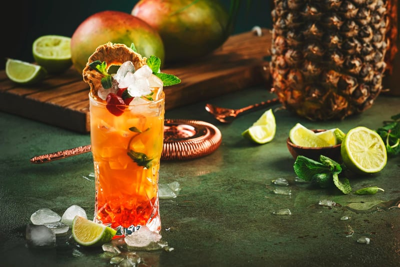 alcoholic-cocktail-with-vodka-pineapple-juice-mango-red-syrup-ice-long-drink-summer-cold-mocktail-tropical-dark-background-with-palm-leaves-exotic-fruits